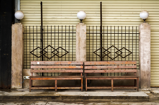 An old wooden bench in an old neighborhood outdoors