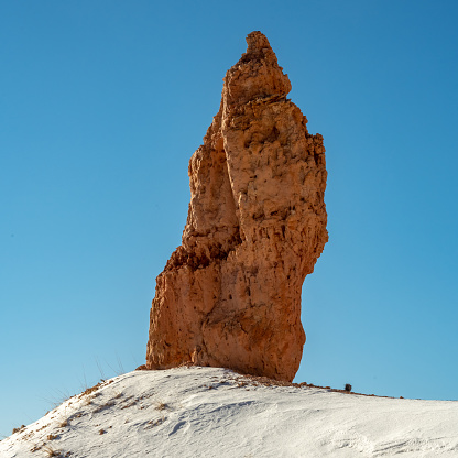 Towering Hoodoo in Bryce Against Blue Sky on a clear winter morning