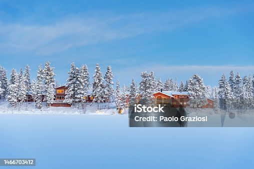 istock Wooden chalets among snow covered trees, Lapland, Sweden 1466703412