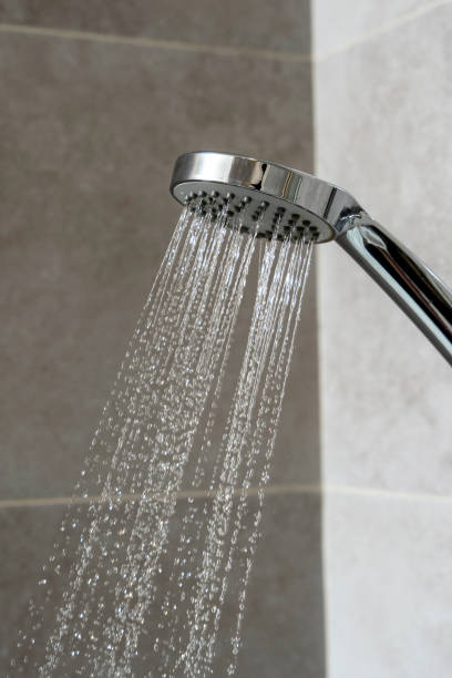 istock water pours from the shower head. shower-bath. Close up 1466704306