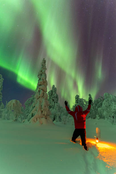 istock Man in the forest with northern lights (aurora borealis) 1466704440