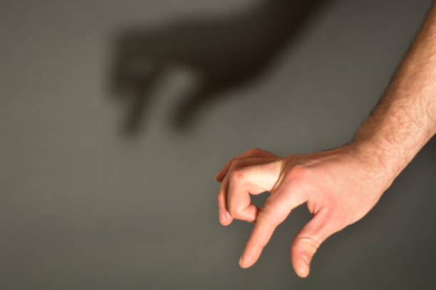 istock Hand showing crocodile with shadow on a gray background 1466710452