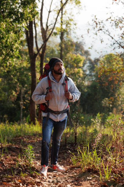 istock Young India man backpack and admiring nature in forest 1466711299
