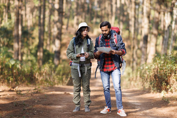 istock Adventurous couple looking the map in the forest 1466711560