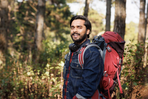 istock Portrait Young India man backpack smile in forest 1466711564