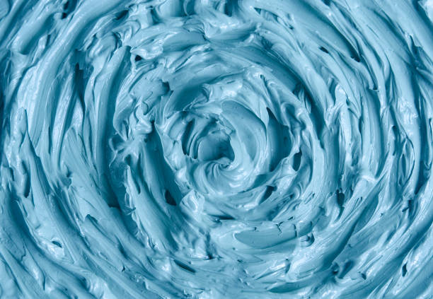 istock Light blue bentonite clay (face cream, alginate facial mask, body wrap, hair conditioner) texture close up, selective focus. Abstract background with circle brush strokes. 1466713141