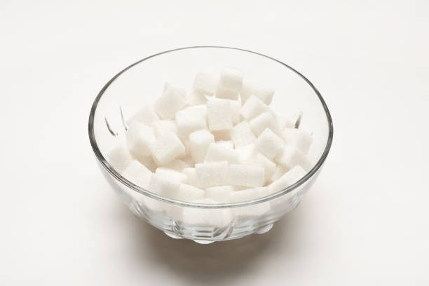 istock Sugar cubes in a glass bowl on the white background 1466715267