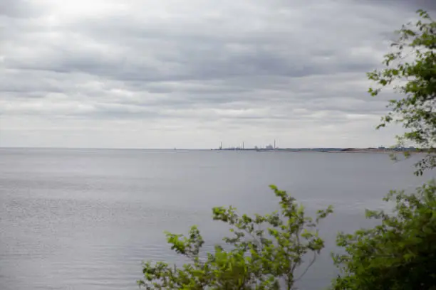 Photo of A view of Lake Ontario from a cottage. Peaceful summer sky and blue water.