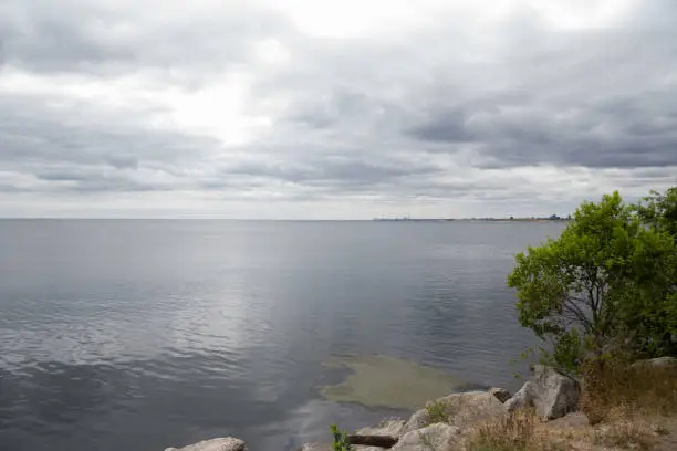 Photo of A view of Lake Ontario from a cottage. Peaceful summer sky and blue water.