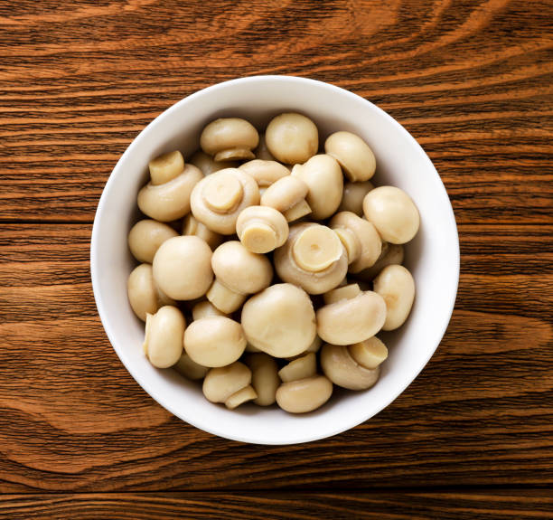istock Marinated mushrooms in a plate on a wooden background. Top view 1466717427