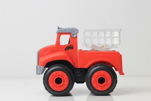 children's toy truck in red on a white background.