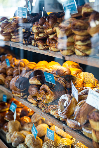 various buns and breads on showcase on Torvehallerne market in Copenhagen.