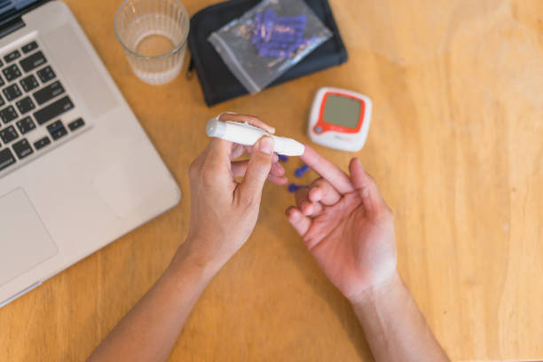 istock young woman using blood test kit at home while doing health check . home finger prick blood test . close up, diabetes concept, elderly health care, 1466723371