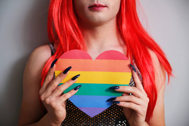 istock Unrecognizable transgender person holding a rainbow flag heart. 1466723623