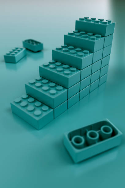 Children's plastic building blocks constructing a staircase illustrating moving forward concept.