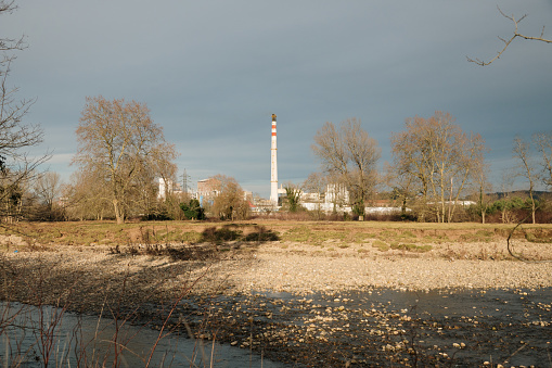 An industrial complex with a large chimney