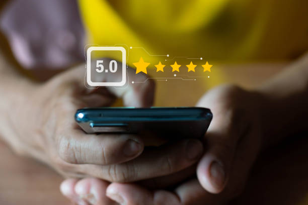 istock Customers using mobile phones rate their satisfaction with the application 5 stars. 1466727917