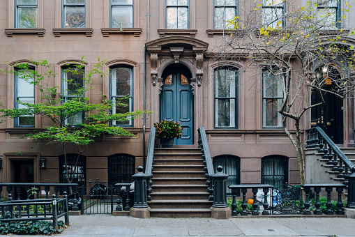 New York, USA - November 21, 2022: Exterior of a traditional house with a stoop in West Village, a charming area of Manhattan famous for its shops and restaurants.