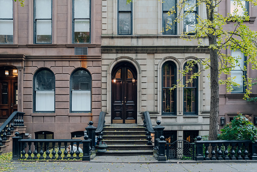 New York, USA - November 21, 2022: Exterior of a traditional townhouse with a stoop in West Village, a charming area of Manhattan famous for its shops and restaurants.