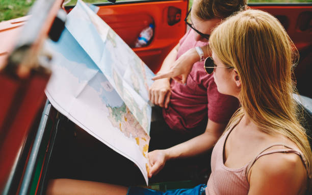 istock Concentrated on map couple in car 1466729797