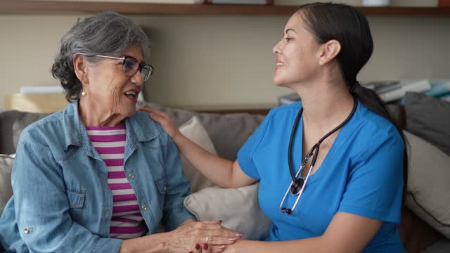 Senior woman talking with her nurse during consultation at nursing home