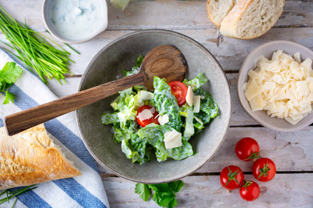 istock Green salad with tomatoes, bread and parmesan cheese 1466733204