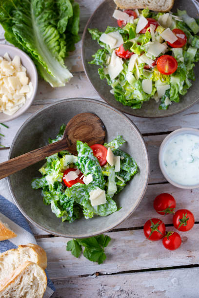 istock Green salad with tomatoes, bread and parmesan cheese 1466733279