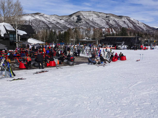 People preparing to ski or resting at the base of Buttermilk Ski Resort, Aspen, Colorado. Aspen, Colorado, USA- February 11, 2023: People preparing to ski or resting at the base of Buttermilk Ski Resort, Aspen, Colorado. buttermilk mountain stock pictures, royalty-free photos & images