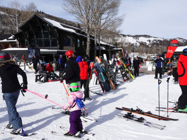 People preparing to ski or resting at the base of Buttermilk Ski Resort, Aspen, Colorado. Aspen, Colorado, USA- February 11, 2023: People preparing to ski or resting at the base of Buttermilk Ski Resort, Aspen, Colorado. buttermilk mountain stock pictures, royalty-free photos & images