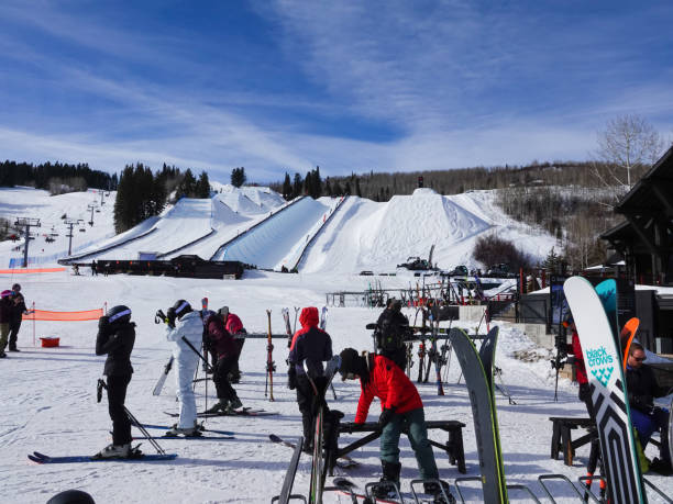 People preparing to ski or resting at the base of Buttermilk Ski Resort, Aspen, Colorado. Aspen, Colorado, USA- February 11, 2023: People preparing to ski or resting at the base of Buttermilk Ski Resort, Aspen, Colorado. buttermilk mountain stock pictures, royalty-free photos & images