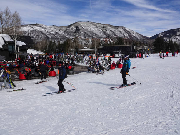 People preparing to ski or resting at the base of Buttermilk Ski Resort, Aspen, Colorado. Aspen, Colorado, USA- February 11, 2023: People preparing to ski or resting at the base of Buttermilk Ski Resort, Aspen, Colorado. buttermilk mountain stock pictures, royalty-free photos & images