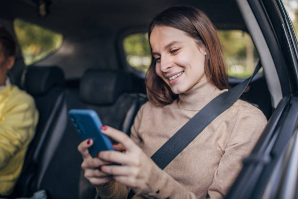 istock Woman using mobile in a taxi 1466734143