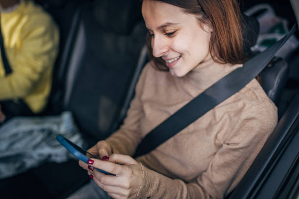 istock Woman using mobile in a taxi 1466734305