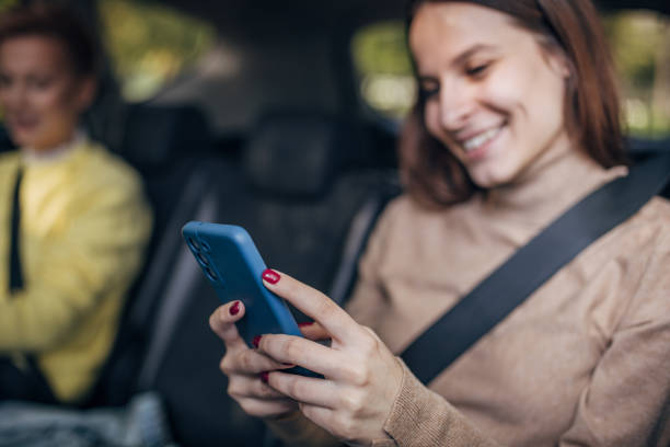 istock Woman using mobile in a taxi 1466734375