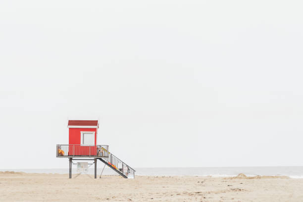istock a red beach hut by the sea with a light background 1466734627