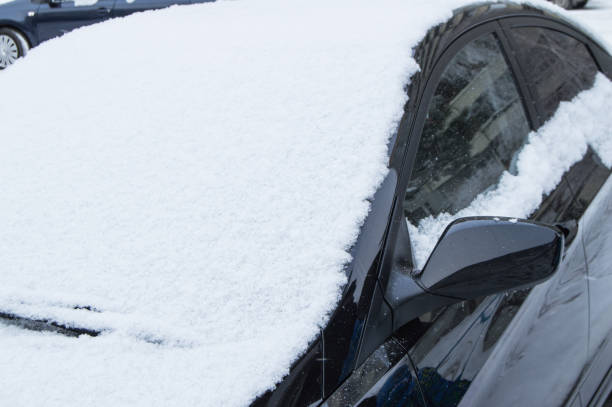 istock The parked car is on the road, covered with snow 1466734773