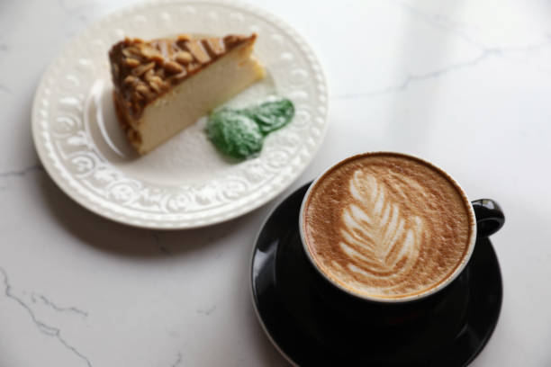 istock Cup of fresh coffee and dessert on white marble table, above view 1466741572