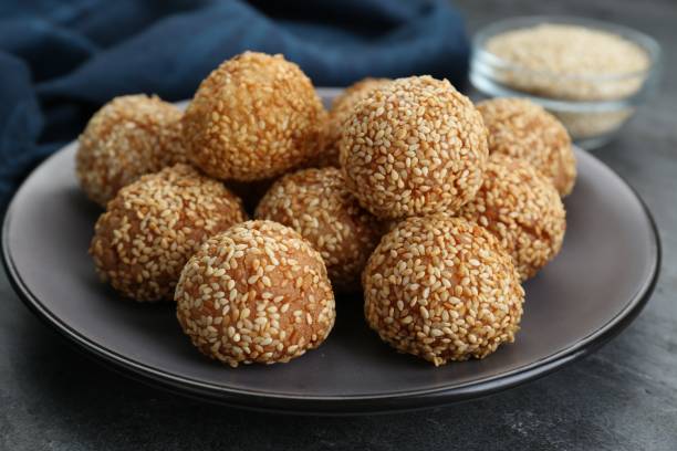 istock Many delicious sesame balls on grey table, closeup 1466741715