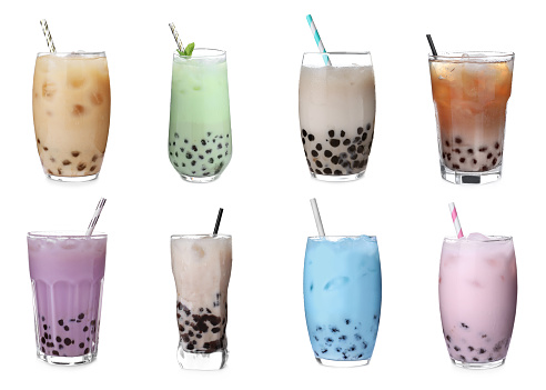 Set with different flavors of bubble tea on white background