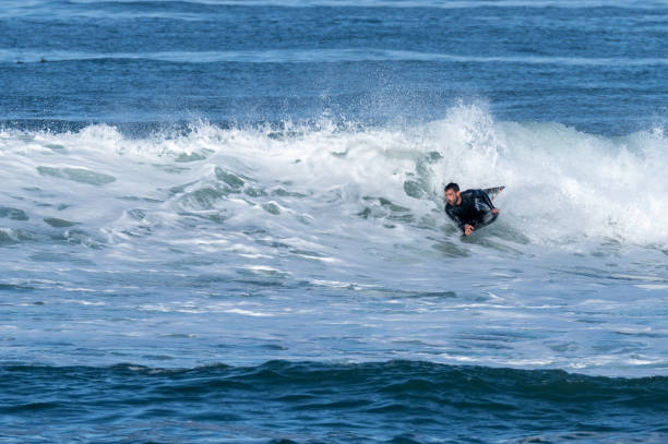 istock Bodyboarder surfing ocean wave 1466743869