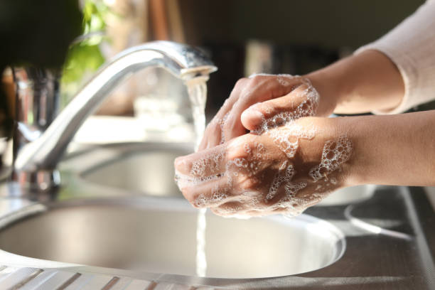 istock Woman washing hands in kitchen, closeup view 1466744413