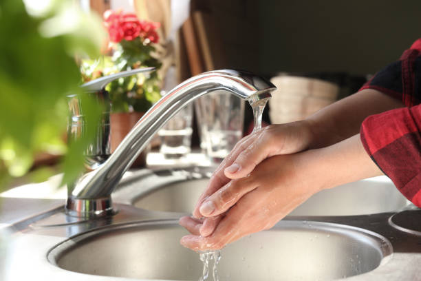 istock Woman washing hands in kitchen, closeup view 1466744531