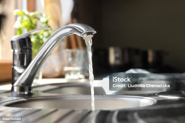 Water Running From Tap Into Kitchen Sink Stock Photo - Download Image Now - Faucet, Water, Kitchen
