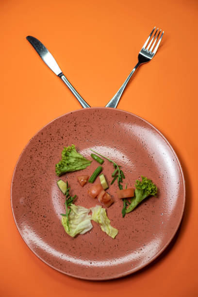 istock Diet vegetables on a plate with fork and knife 1466744731