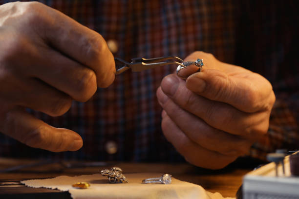 istock Professional jeweler working with ring at wooden table, closeup 1466744799