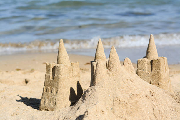 istock Beach with sand castle near sea on sunny day 1466745918