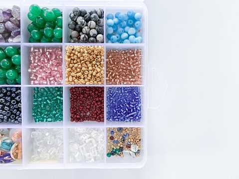 Storage container box of colourful beads with copy-space