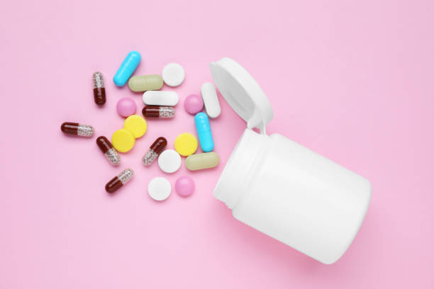 istock Bottle and antidepressant pills on pink background, flat lay 1466748337