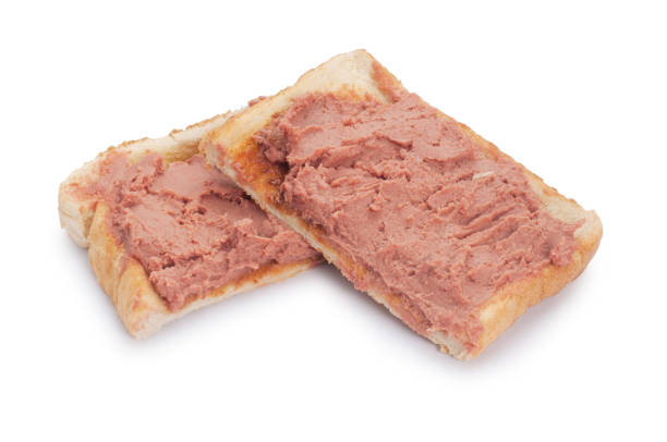 Studio shot of chicken liver pate spread on white toast cut out against a white background