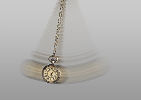 Hypnosis session. Vintage pocket watch with chain swinging on light background, motion effect